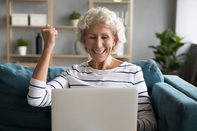 Older women in front of computer celebrating