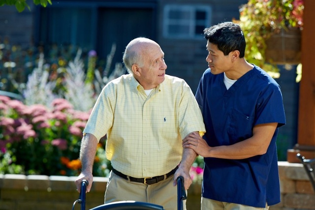 Fall Prevention for Seniors – man with walker and assistant