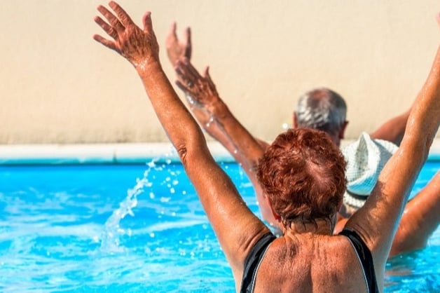 Aqua therapy, seniors swimming in pool