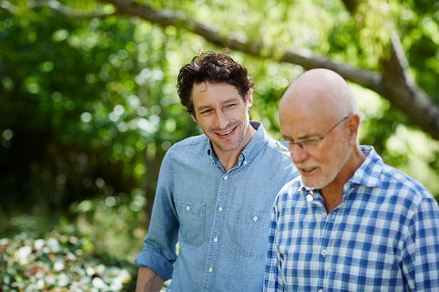 Younger man talking with loved one about moving parent to senior living 