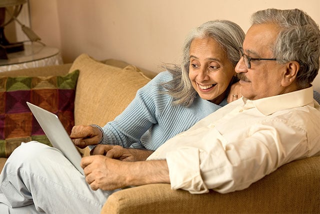 two seniors looking at senior living resouces on thier computer